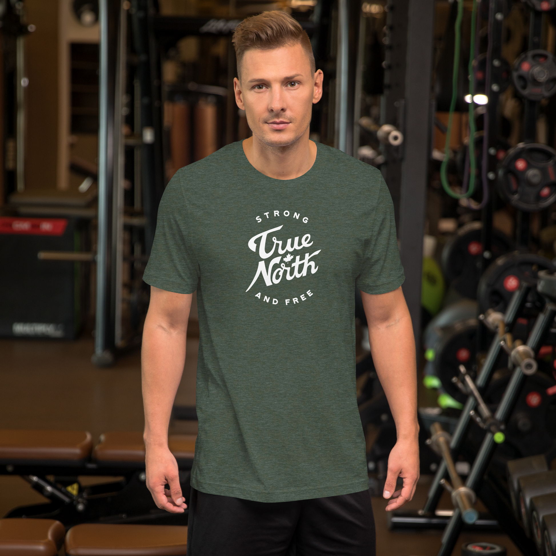 Man wearing a green t-shirt with 'True North Strong and Free' text in a gym setting
